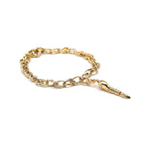 Tadpole Charm in 18K Gold made with White Diamond on a bracelet flat lay