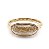 Terrarium Bangle in 18K Gold with diamonds mother of pearl and rock crystal flat lay