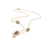 Frog Necklace in 18K Gold made with Rock Crystal with Abalone and Black Enamel flat lay